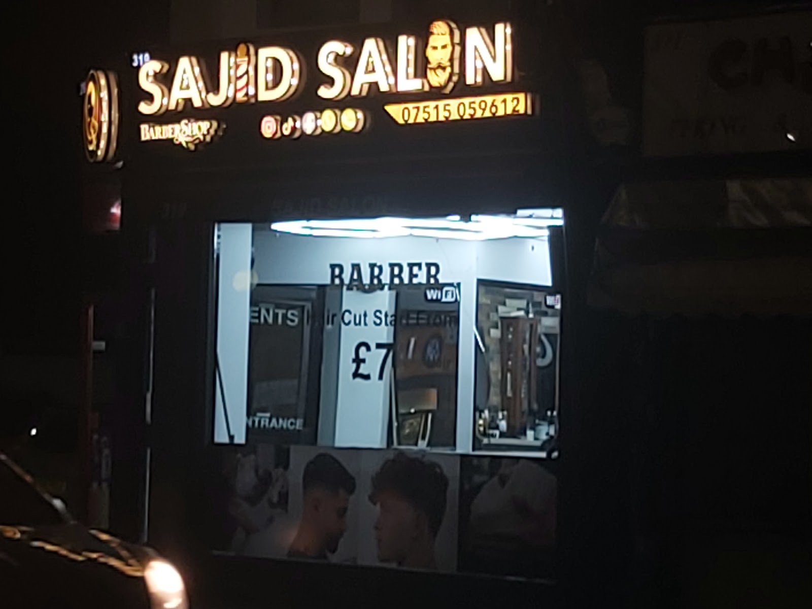 The shopfront glowing on a quiet evening street